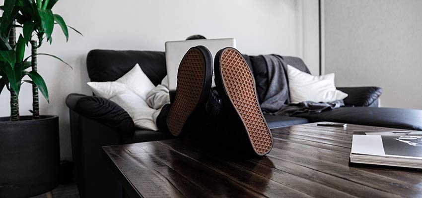 A person with their feet up on a table - Working from Home