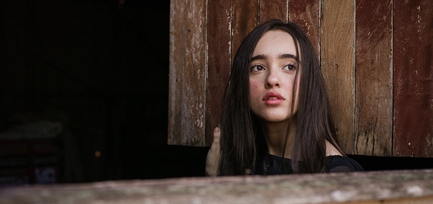 A young girl looks off into the distance.