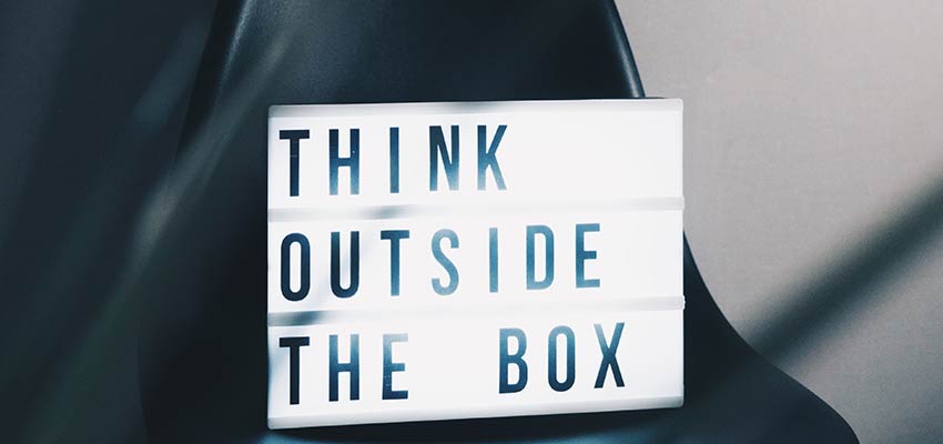 A sign that reads "Think Outside the Box".